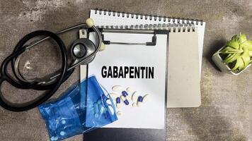 Concept of Gabapentin write on paperwork isolated on Wooden Table. photo