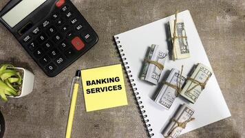 Concept of Banking Services write on sticky notes isolated on Wooden Table. photo