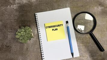 Concept of Cybersecurity Plan write on sticky notes isolated on Wooden Table. photo