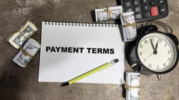 Concept of Payment Terms write on book isolated on Wooden Table. photo