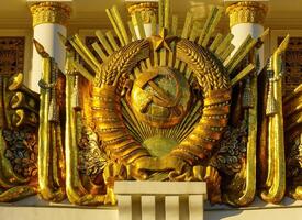 A golden statue of a man with a crown on top of a building photo