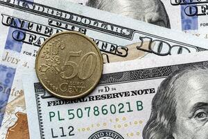 A one dollar coin is sitting on top of a pile of us dollars photo