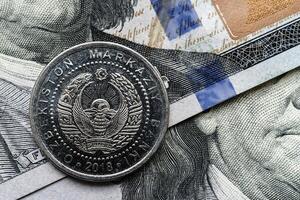 A coin is sitting on top of a stack of money photo