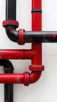 Red and black water pipes forming a tangled network structure, highlighting engineering photo