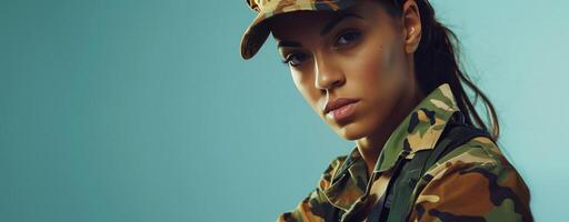 Fearless young servicewoman in camouflage military outfit, confident against blue background photo