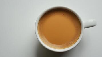 Top view of a cup filled with frothy cappuccino on a white background photo