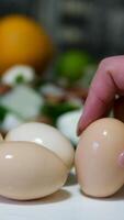 Close-up of female hands peels boiled egg. Peeling eggs from the shell. Cooking dinner or salad with boiled eggs video
