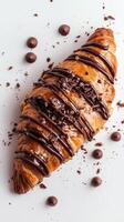 Delicious chocolate croissant with chocolate on white background with scattered pieces photo
