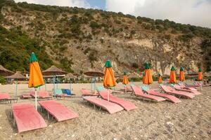 the beach in Albania with empty sunbeds ready to receive tourists. photo
