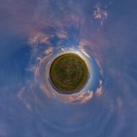 A small planet with a sky and clouds photo