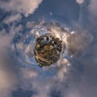 A small planet with clouds and a building in the sky photo