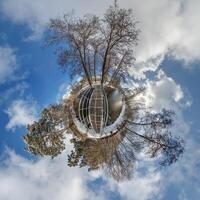 A small planet with trees and a building photo