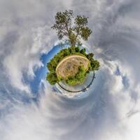 A small planet with a tree in the middle photo