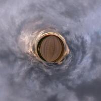 A circular view of a field with clouds photo