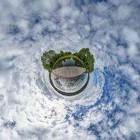A small planet with a bridge and trees photo