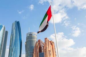 Abu Dhabi, UAE 04 january 2025 the flag of the united arab emirates on the background of the modern buildings of abu dhabi photo
