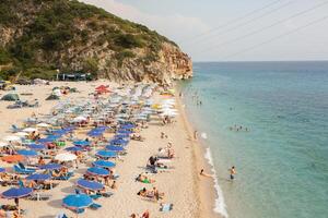 Saranda, Albania September 09 2024 tourist are relaxing on the Gjipe Beach A Hidden Gem Between Mountains and Sea photo