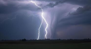 Lightning strikes over a field in the middle of a storm photo