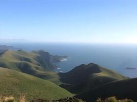 A view of the ocean and hills from a mountain photo