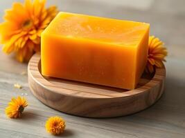 A soap bar with yellow flowers on a wooden table photo