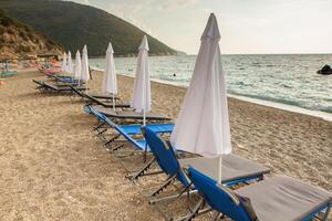the beach in Albania with empty sunbeds ready to receive tourists photo