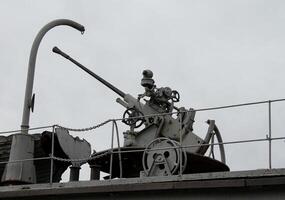 Silhouette Of Heavy Gun On A Platform At Military Ship photo
