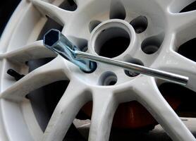 Hand Lug Wrench In Car Wheel Detailed Photo