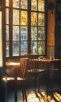 A cozy cafe corner illuminated by golden sunlight streaming through a large window pane photo