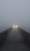 Ethereal Encounter Vehicle on a Misty Bridge Creating a Sense of Mystery and Intrigue photo