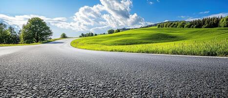 Curving empty road scenic landscape green hills outdoor photography bright sky low angle view tranquil journey photo