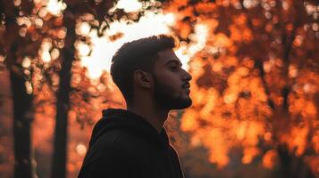 Contemplative portrait of a man in nature autumn landscape profile view serene atmosphere for emotional reflection photo