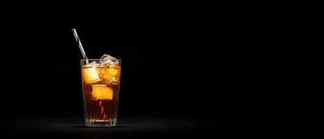 Refreshing glass of caramel-colored cola with ice cubes studio setting beverage photography low light environment photo