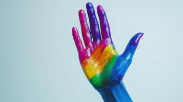 Rainbow painted hands reaching up in proud support, showcasing vibrant colors and empty text space photo