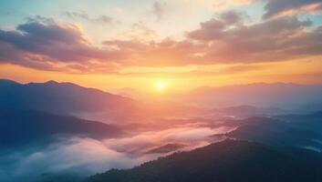 The sun rising over the mountains in a beautiful sky photo