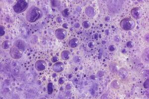 A close up of a purple surface with bubbles photo