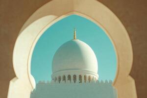 A view of the dome of a mosque through an arch photo