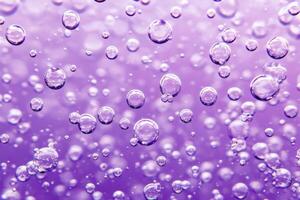 Water bubbles on a purple background photo