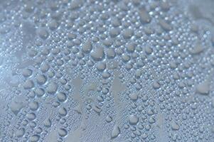 Raindrops gracefully decorate a smooth surface in a calming, serene environment at dawn photo