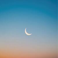 The moon is seen in the sky at sunset photo