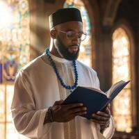 A man in a white robe is reading a book photo