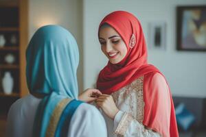 Two women in traditional clothing are smiling at each other photo