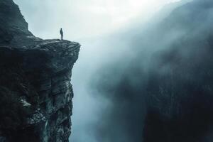 A man standing on the edge of a cliff photo