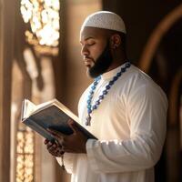 Muslim man reading the quran in a mosque photo