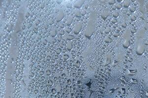 Water droplets cling to a surface after a refreshing rainfall illuminating delicate patterns photo