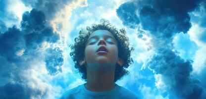 A young boy is looking up into the sky photo