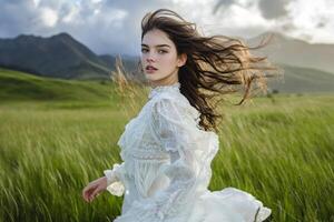 A woman in a white dress running through a field photo