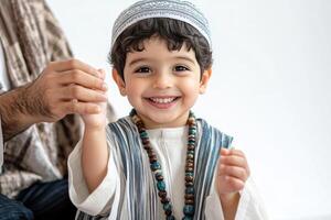 A little boy in a traditional muslim outfit photo