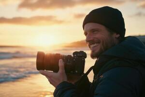 A man is holding a camera at the beach photo
