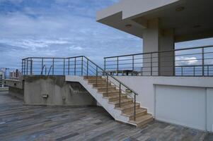 Elegant rooftop terrace with elegant stairs and modern architecture in a coastal city photo