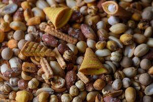Variety of colorful snacks displayed in a vibrant and lively arrangement on a rustic surface photo